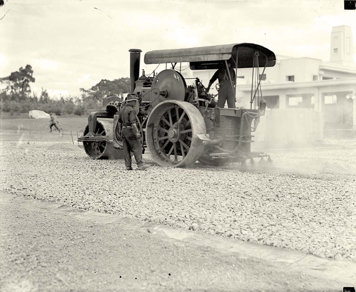 Canberra. Steam roller with attached tar spray at work making roads