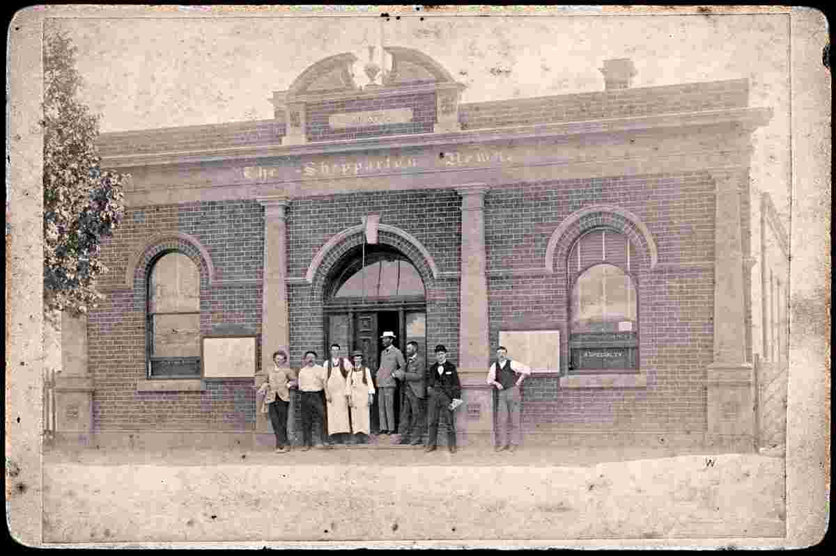 Group standing in front of Shepparton News building, circa 1900