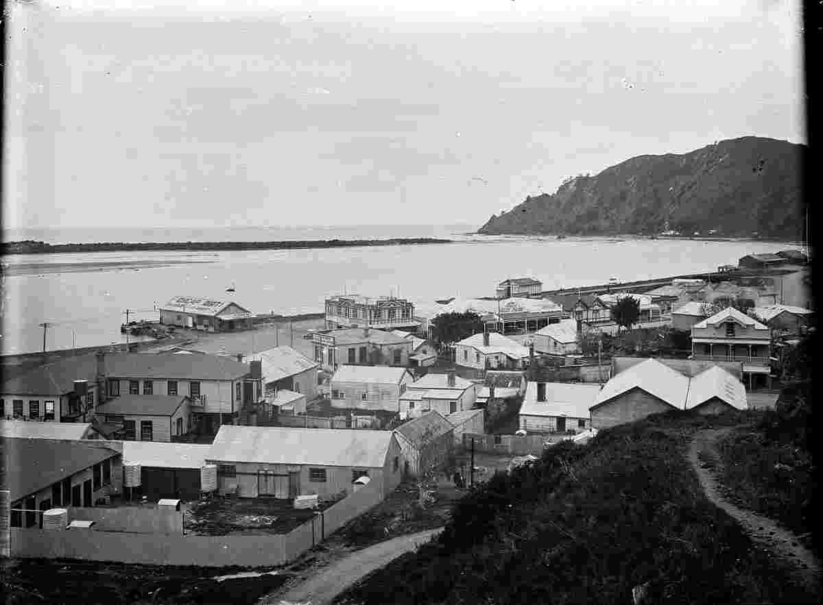 View of Whakatane Harbour and buildings along the waterfront, 1920s