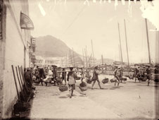 Hong Kong. Coolies with basket yokes in Hong Kong harbor, between 1890 and 1920