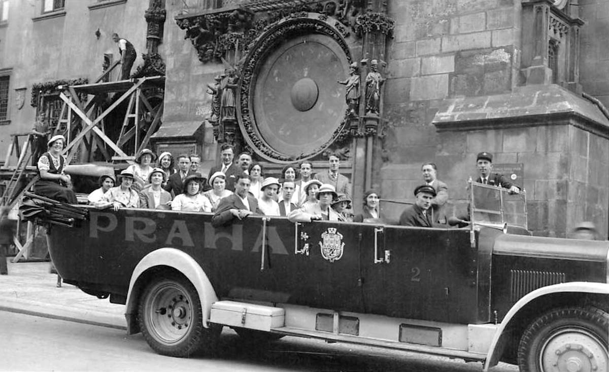 Prague. Group tourists in the bus in front of the astronomical clock